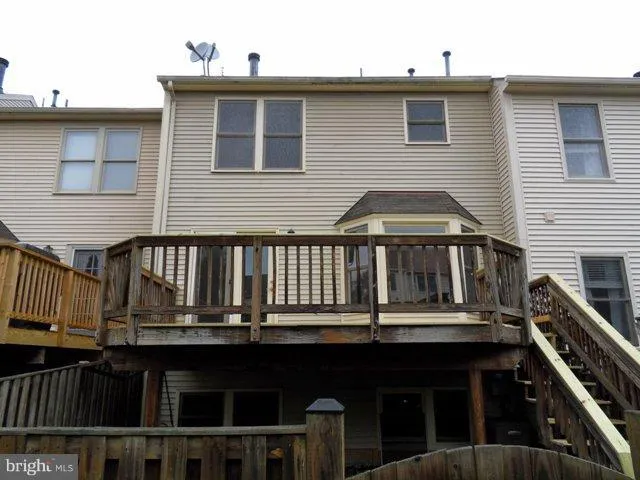 a view of a house with wooden fence