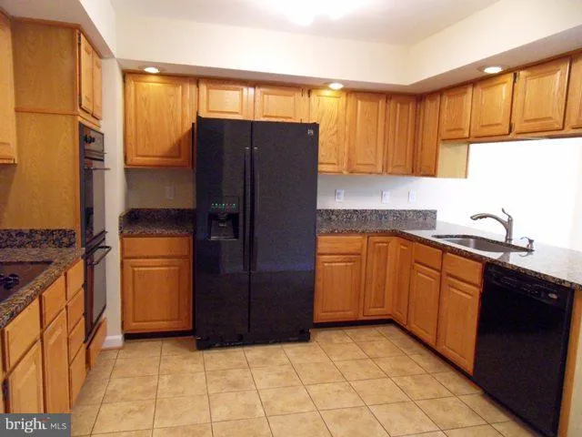a kitchen with a refrigerator and a sink