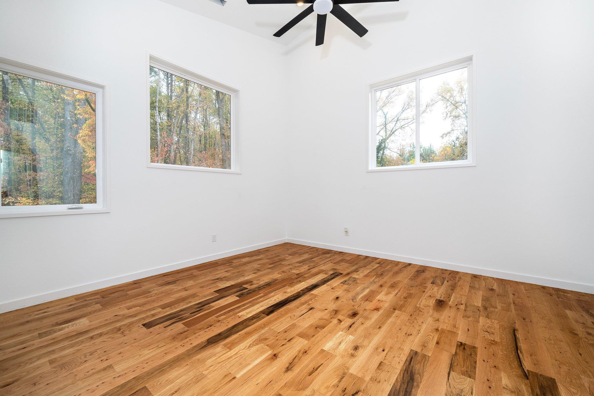 2300 Kilburn Road Raleigh, NC 27604 - Photo 19 of 42 a view of empty room with wooden floor and fan