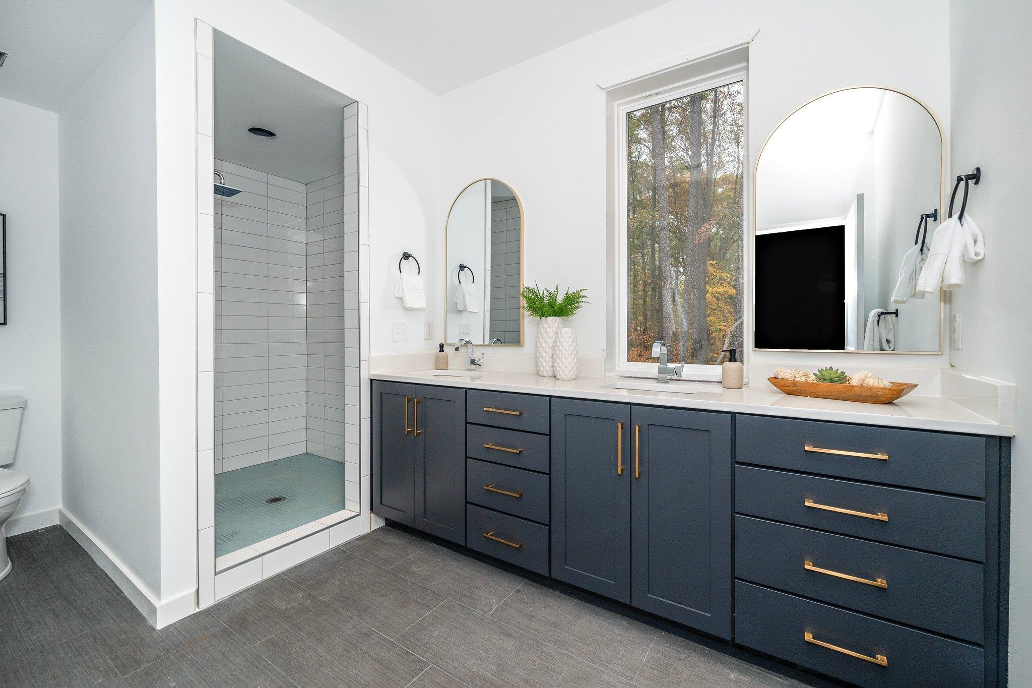 2300 Kilburn Road Raleigh, NC 27604 - Photo 22 of 42 a bathroom with a double vanity sink mirror and bathtub