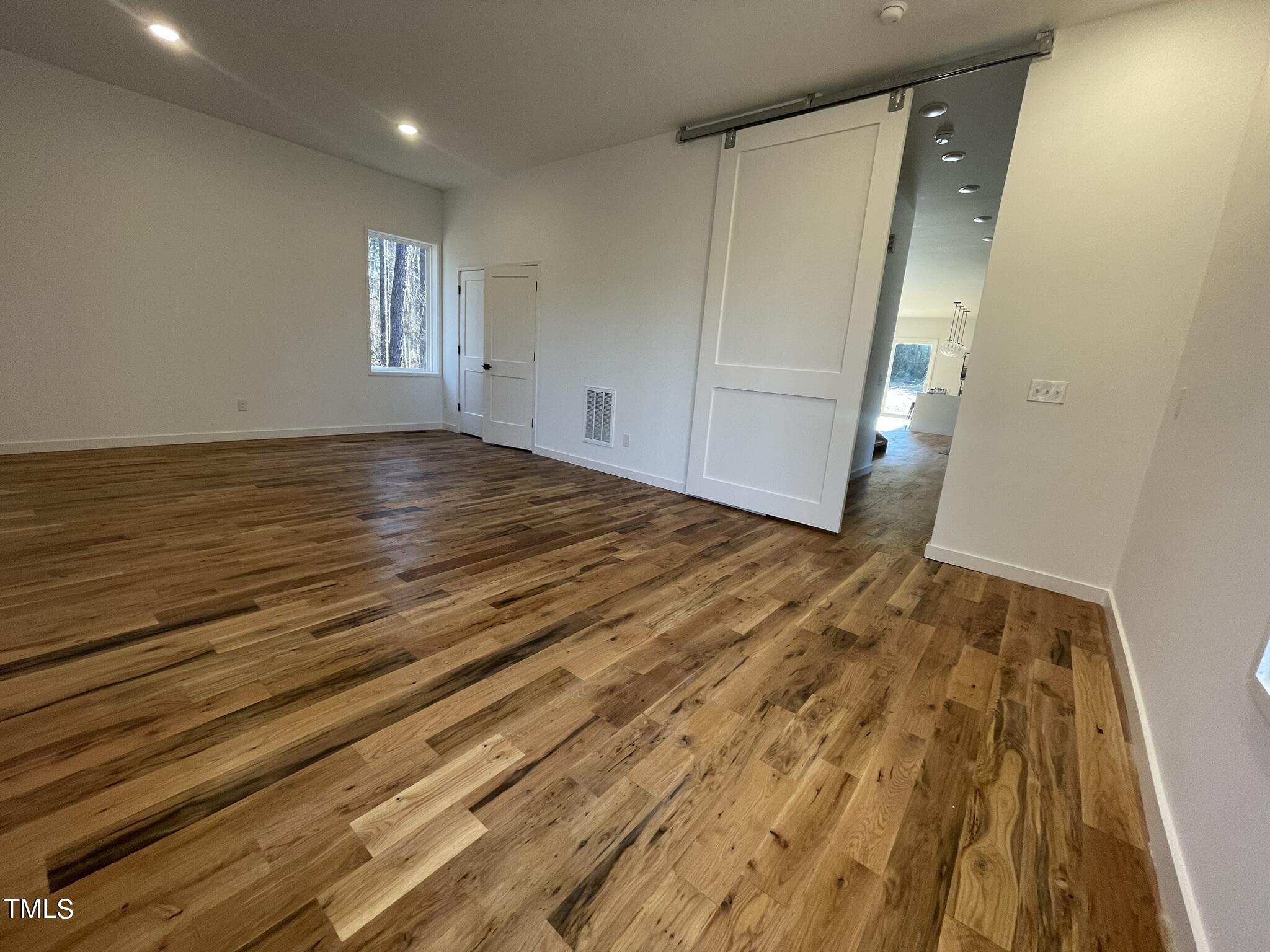 2300 Kilburn Road Raleigh, NC 27604 - Photo 25 of 42 a view of empty room with wooden floor and fan
