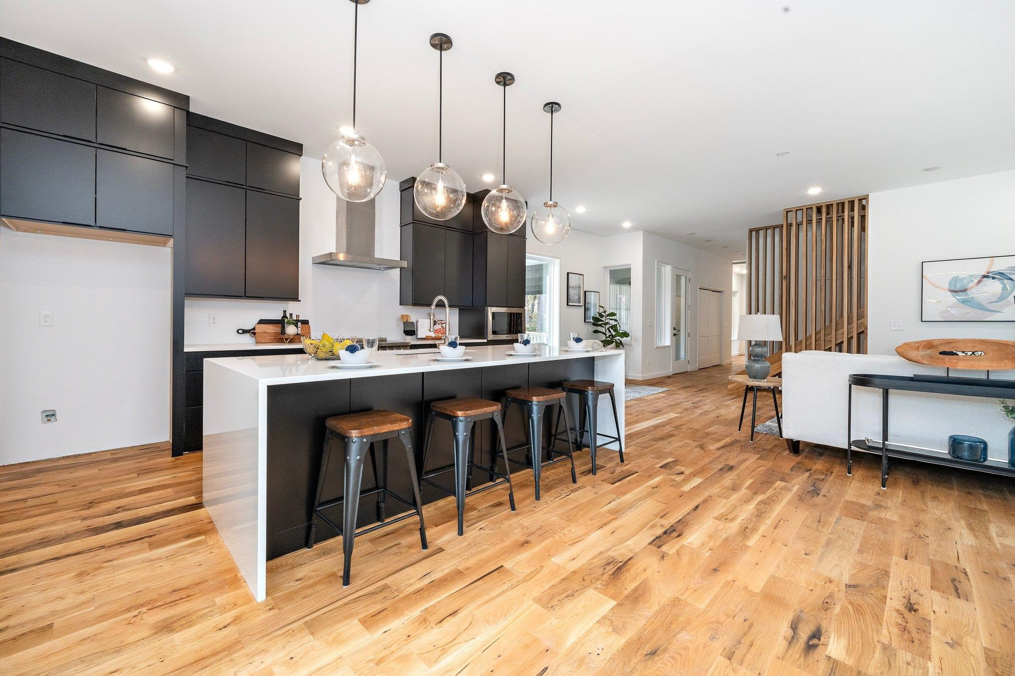 2300 Kilburn Road Raleigh, NC 27604 - Photo 7 of 42 a kitchen with stainless steel appliances kitchen island granite countertop a sink a stove and a wooden floors