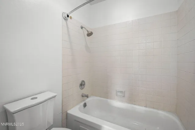 a bathroom with a bathtub and toilet
