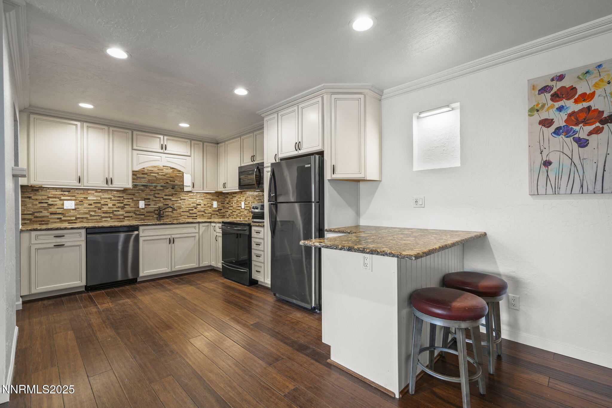 2845 Idlewild Drive, Unit 313 Reno, NV 89509 - Photo 12 of 27 a kitchen with a refrigerator a stove and chairs with wooden floor