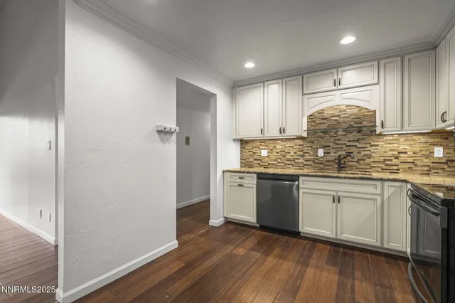a kitchen with granite countertop white cabinets and white appliances