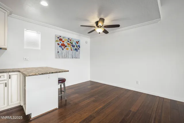 a view of a hallway with wooden floor and closet