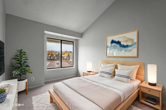 a bedroom with a large bed and a window