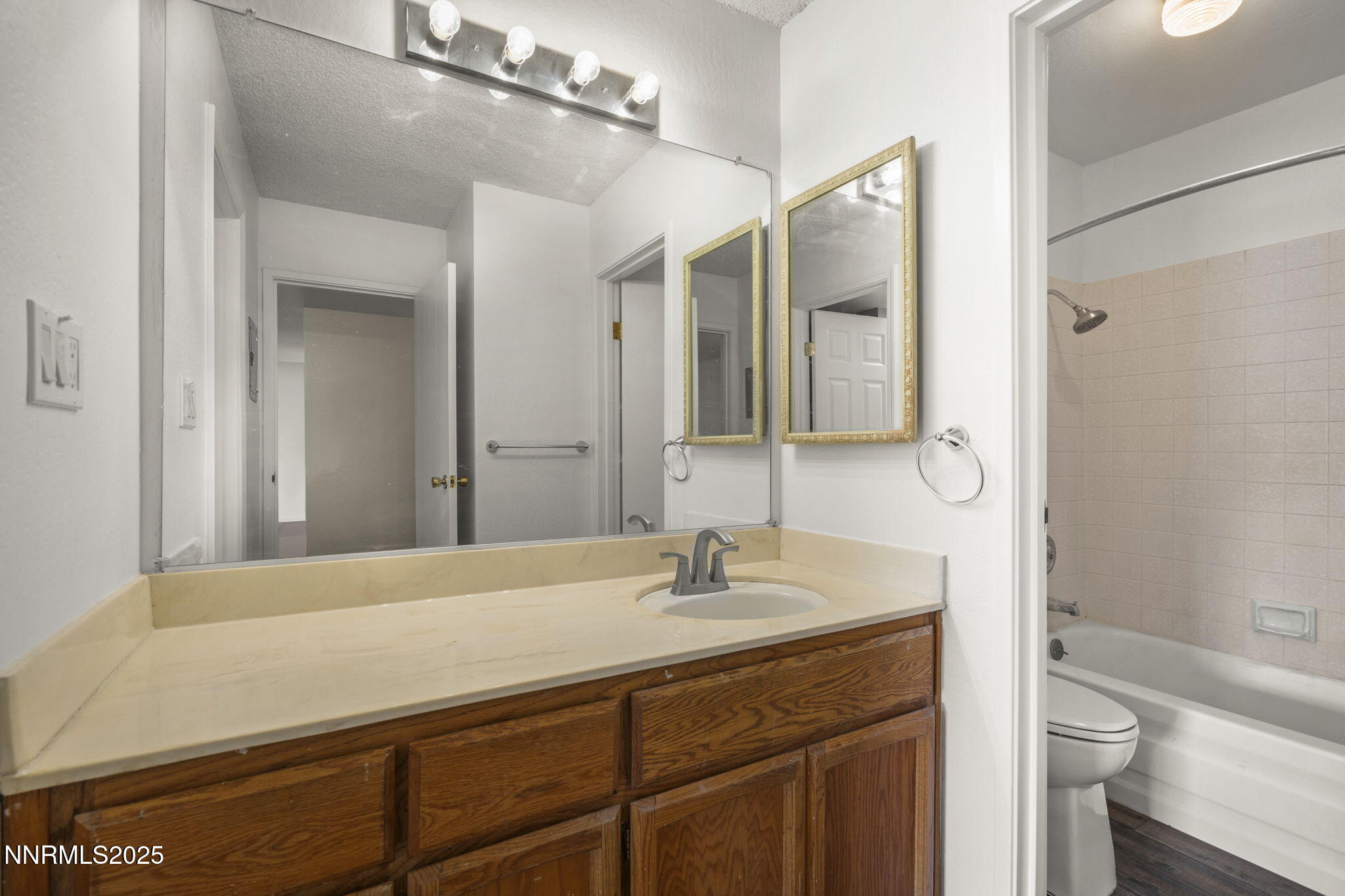 2845 Idlewild Drive, Unit 313 Reno, NV 89509 - Photo 10 of 27 a bathroom with a sink a toilet and shower