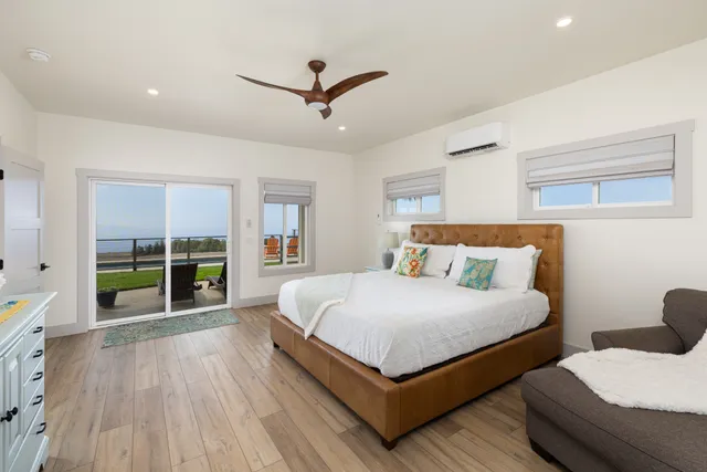 a white bath tub sitting in a bathroom next to a window