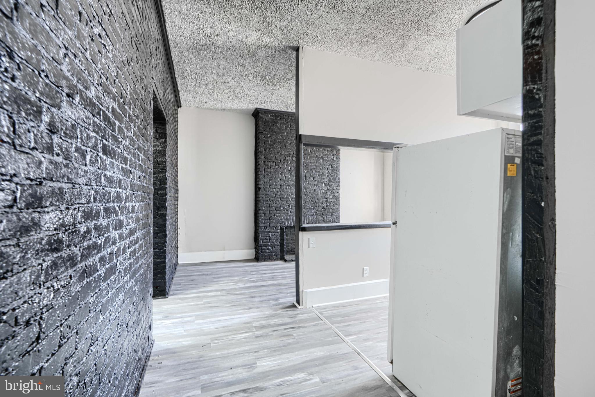 617 North Paca Street Baltimore, MD 21201 - Photo 8 of 20 a view of a hallway with wooden floor and staircase