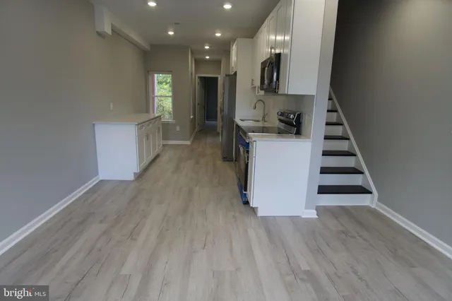 a view of kitchen and hall with wooden floor