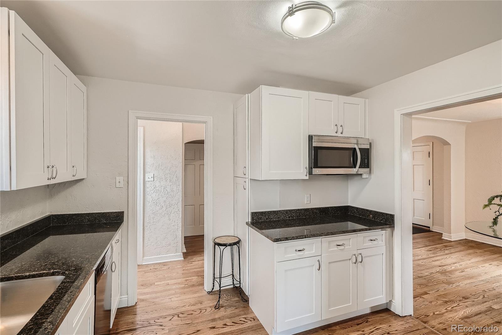 1209 West Ridge Road Littleton, CO 80120 - Photo 11 of 33 a kitchen with stainless steel appliances granite countertop a stove a sink and a refrigerator