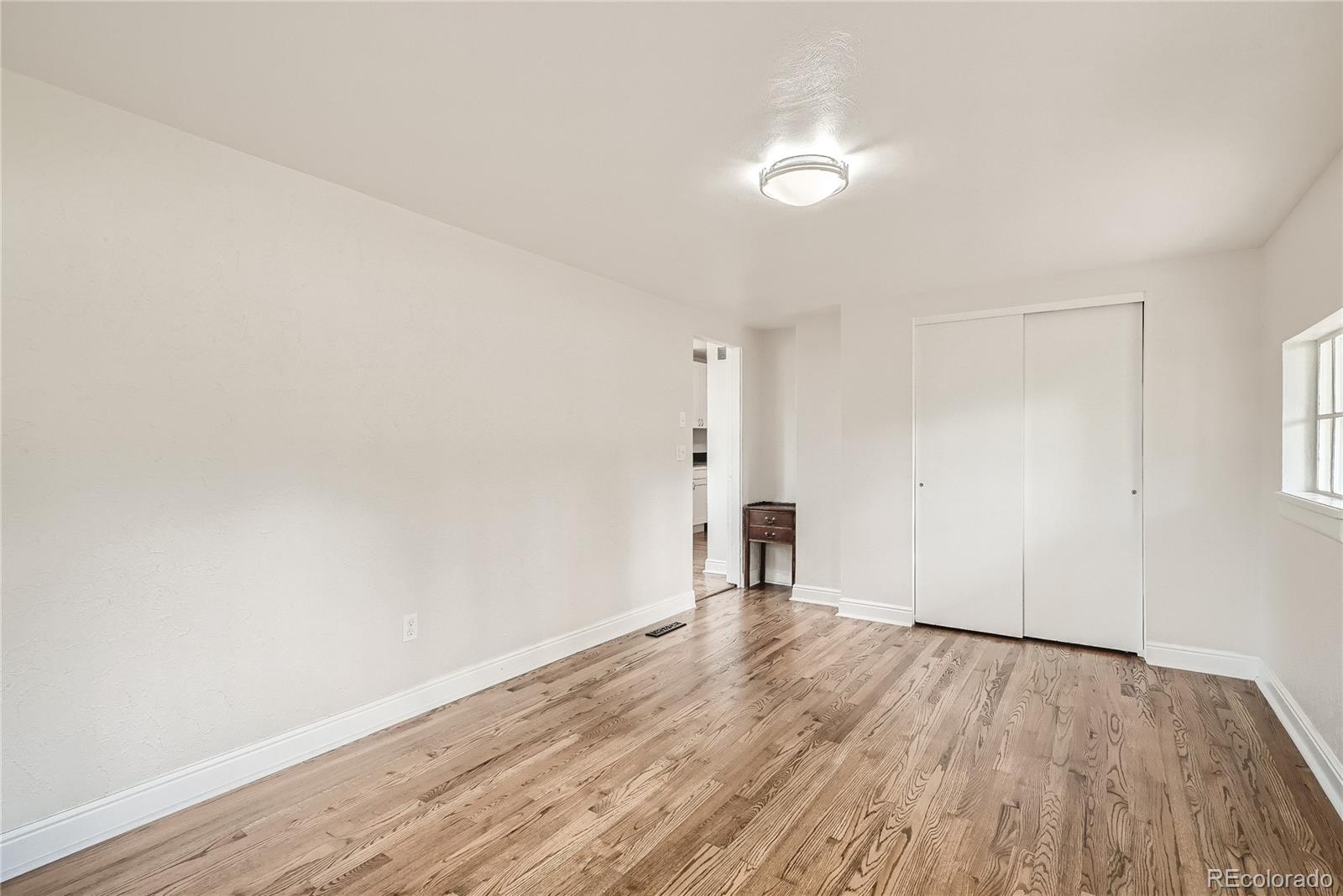 1209 West Ridge Road Littleton, CO 80120 - Photo 15 of 33 an empty room with wooden floor