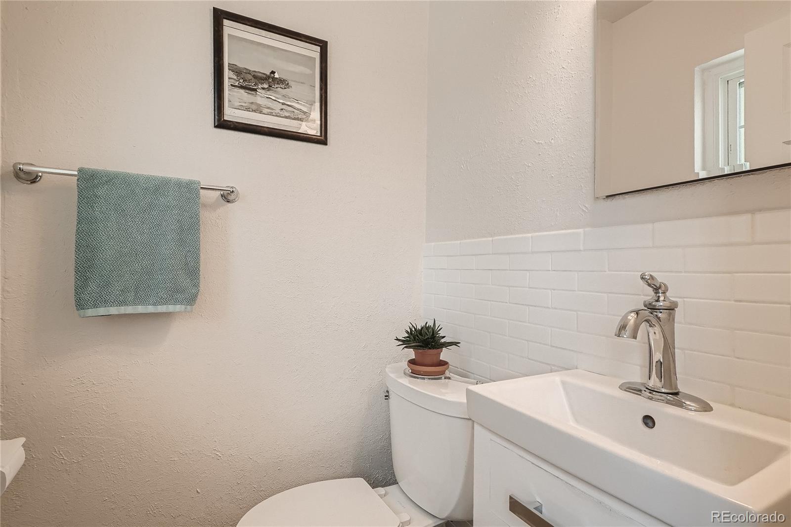 1209 West Ridge Road Littleton, CO 80120 - Photo 16 of 33 a bathroom with a sink mirror and toilet