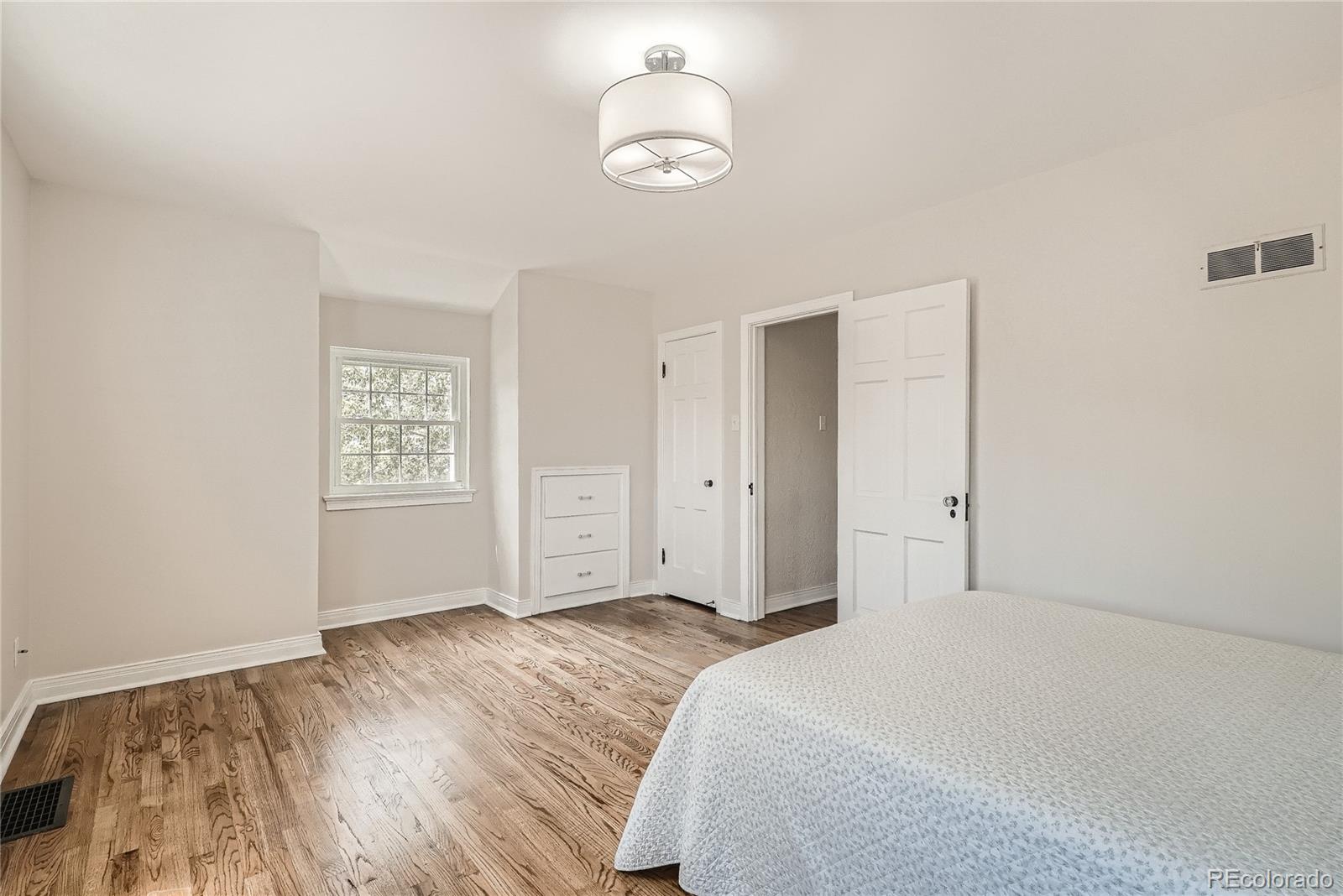 1209 West Ridge Road Littleton, CO 80120 - Photo 18 of 33 a bedroom with a bed and a window