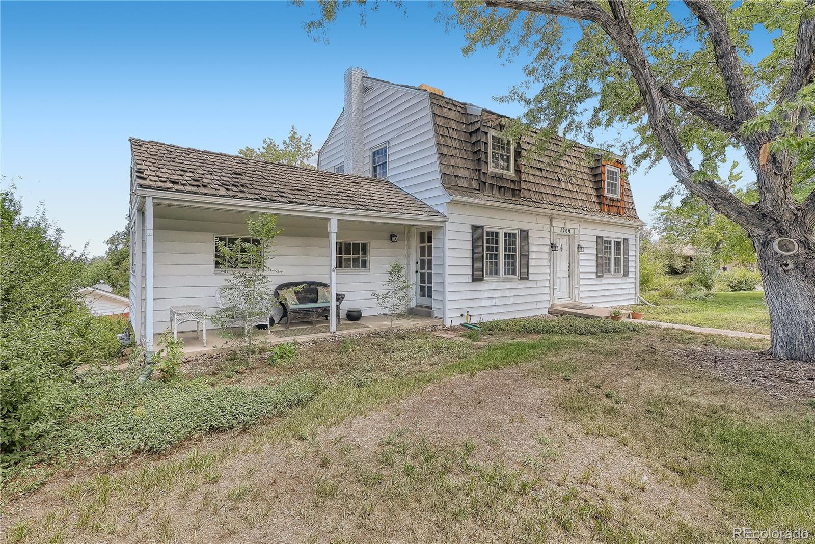 1209 West Ridge Road Littleton, CO 80120 - Photo 2 of 33 a view of a house with a yard