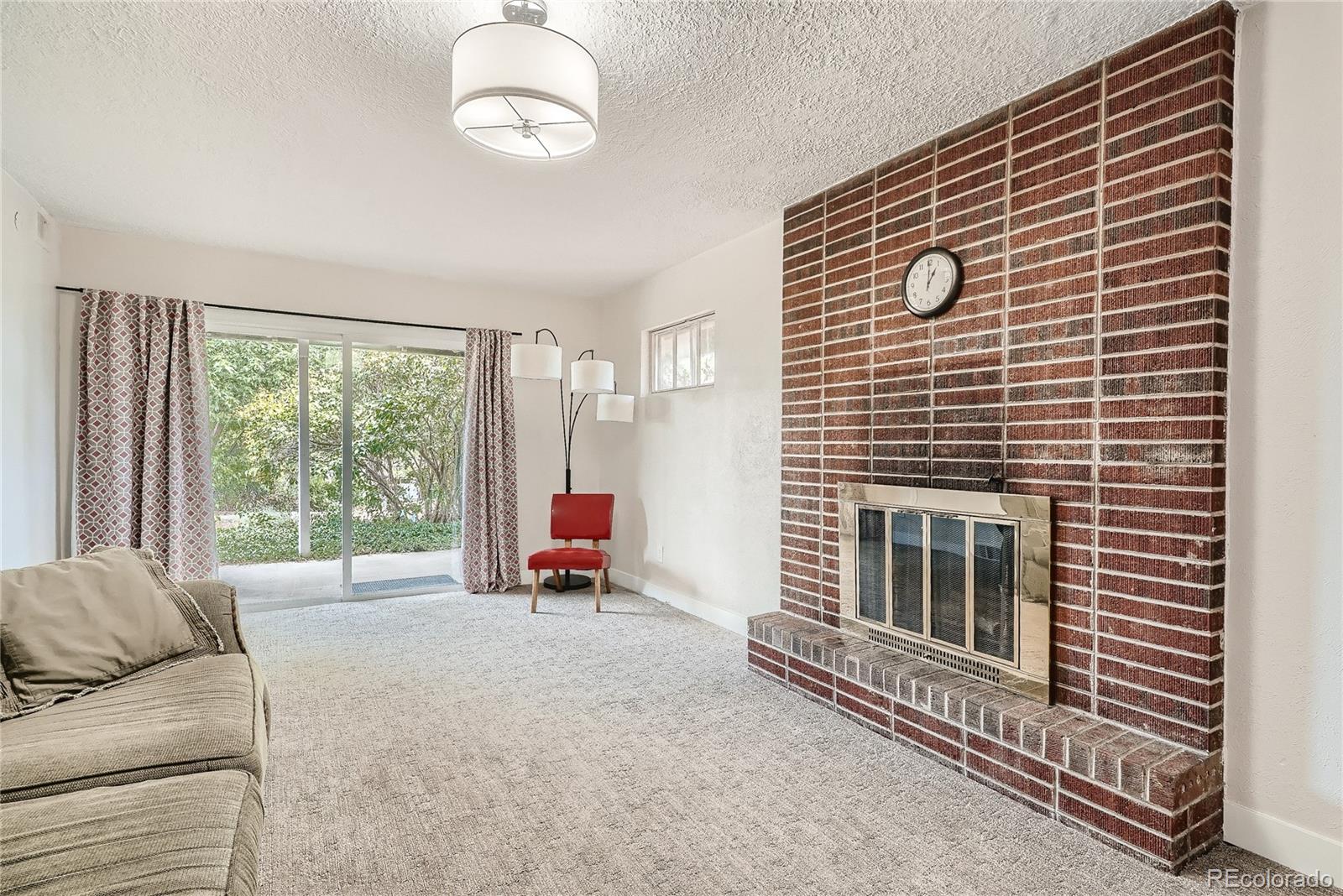1209 West Ridge Road Littleton, CO 80120 - Photo 22 of 33 a living room with furniture windows and a fireplace