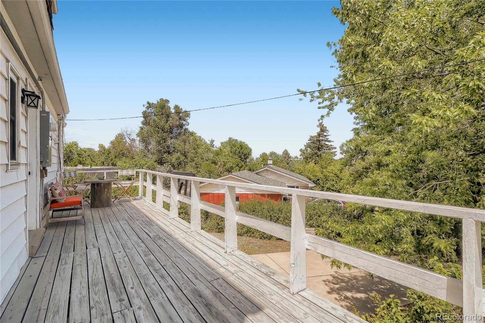 1209 West Ridge Road Littleton, CO 80120 - Photo 26 of 33 a view of balcony with deck and wooden floor