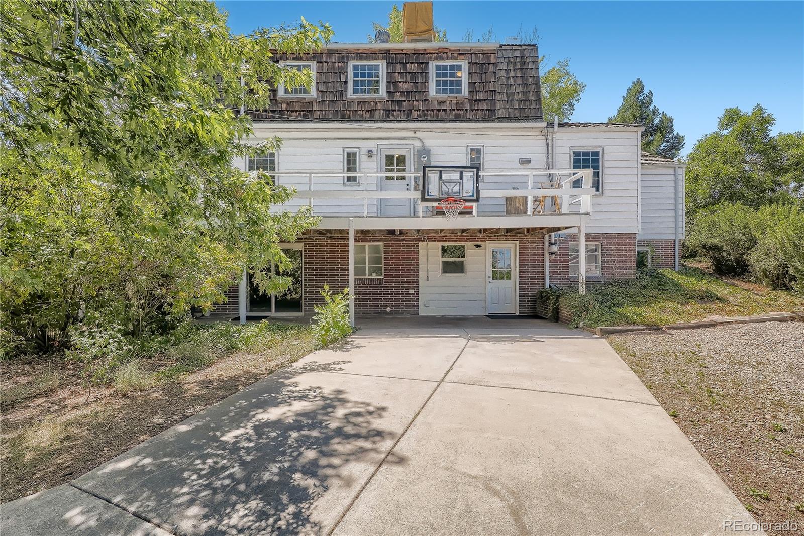 1209 West Ridge Road Littleton, CO 80120 - Photo 29 of 33 a front view of a building with a yard