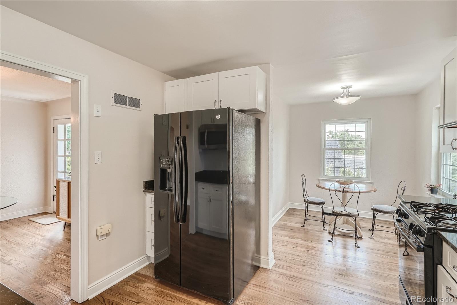 1209 West Ridge Road Littleton, CO 80120 - Photo 8 of 33 a view of kitchen with refrigerator and dining table