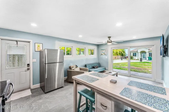 a kitchen with stainless steel appliances granite countertop a stove a refrigerator and a dining table