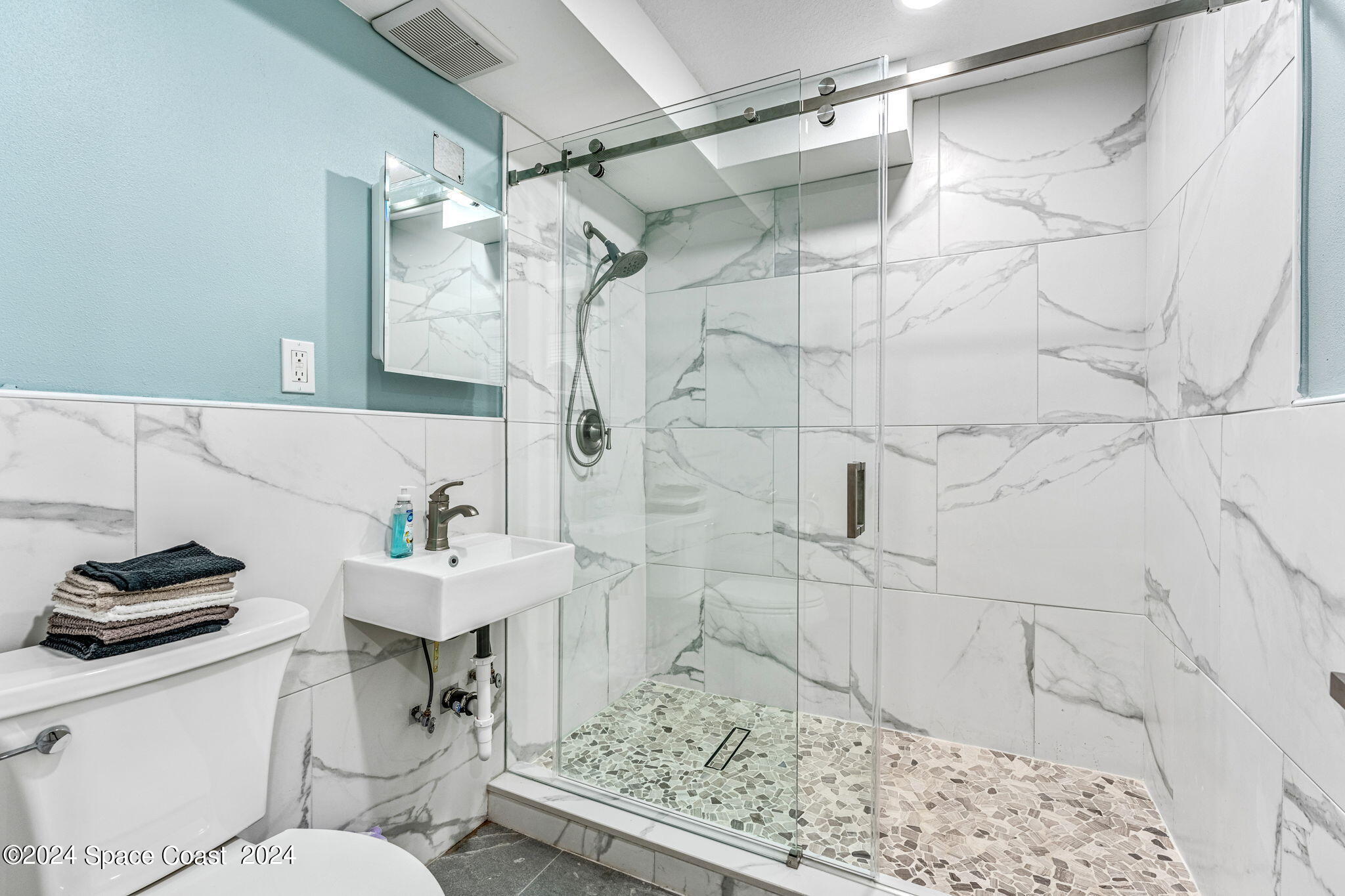 2189 Pineapple Avenue, Unit C Melbourne, FL 32935 - Photo 20 of 67 a bathroom with a sink toilet and shower