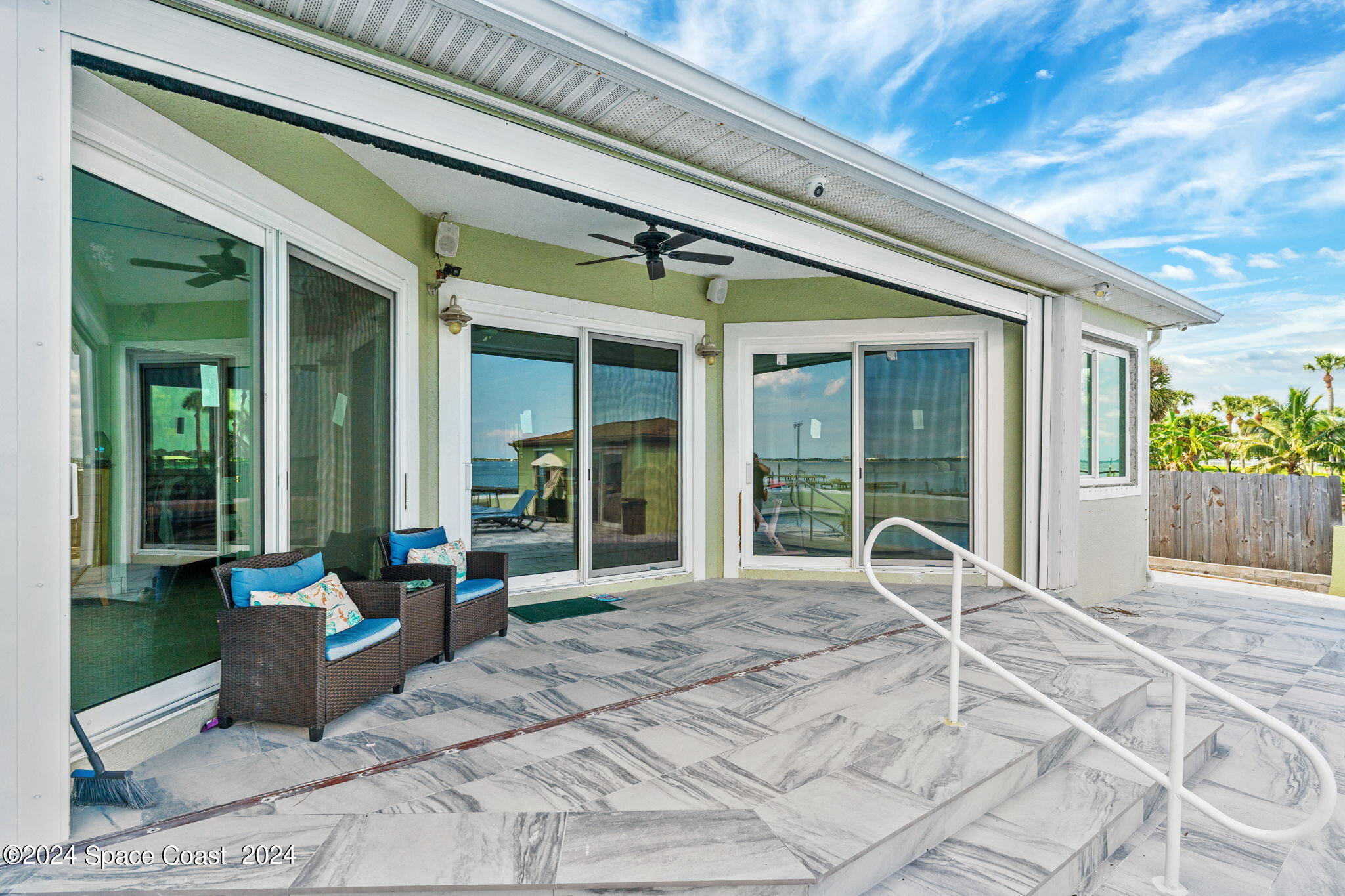 2189 Pineapple Avenue, Unit C Melbourne, FL 32935 - Photo 29 of 67 a view of a patio with table and chairs and potted plants
