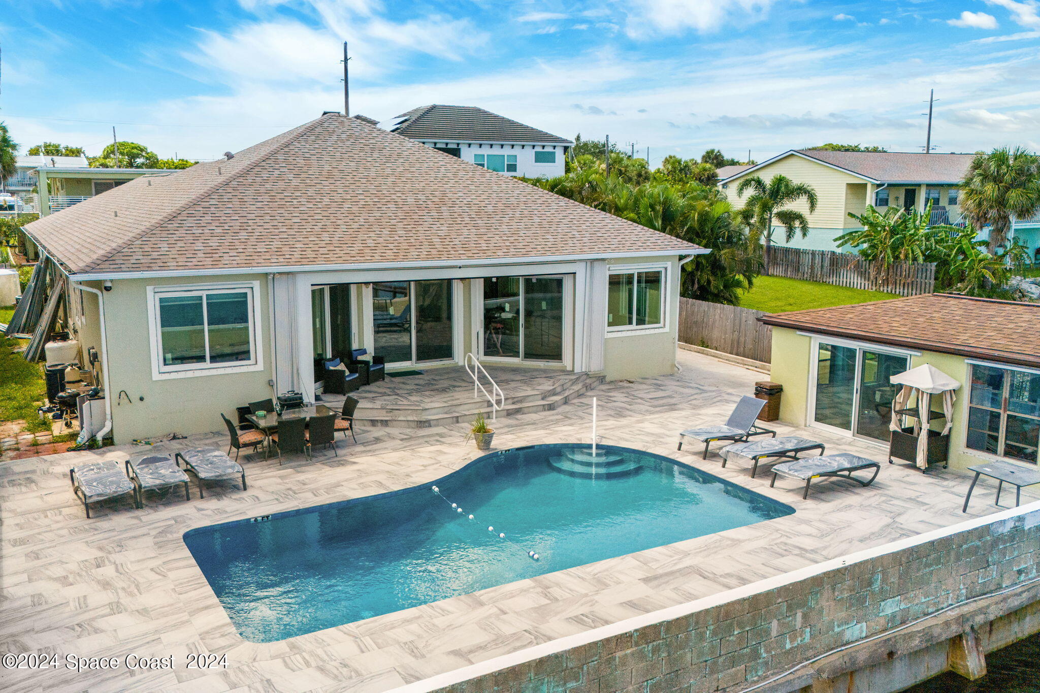 2189 Pineapple Avenue, Unit C Melbourne, FL 32935 - Photo 37 of 67 a view of a house with swimming pool and sitting area