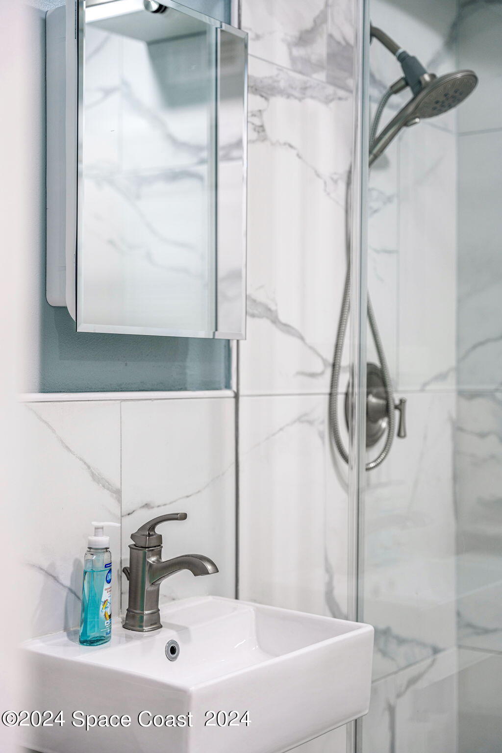 2189 Pineapple Avenue, Unit C Melbourne, FL 32935 - Photo 67 of 67 a bathroom with a sink and a mirror