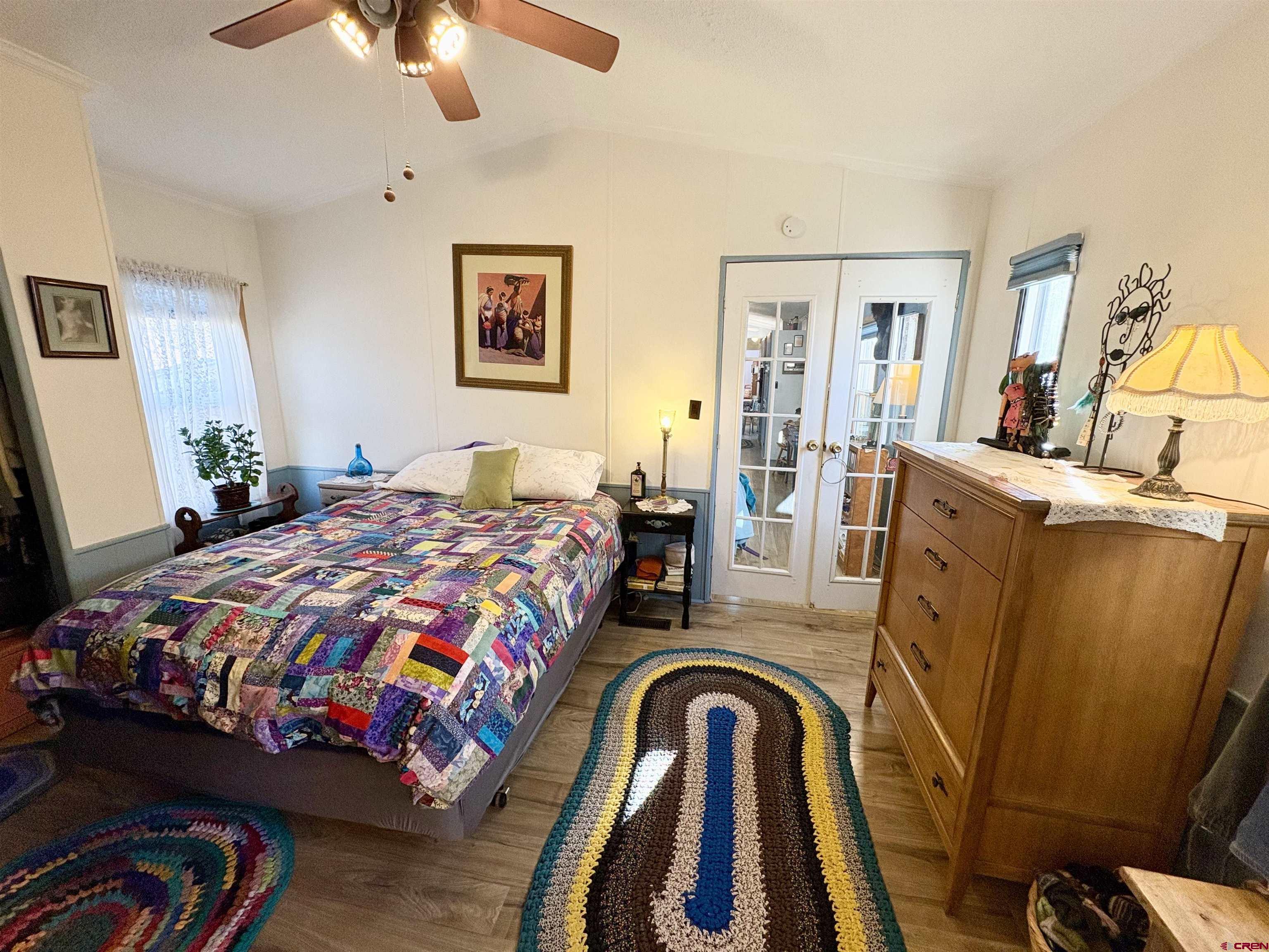 3 Lomas Drive Durango, CO 81301 - Photo 11 of 26 a bedroom with a bed and a chandelier