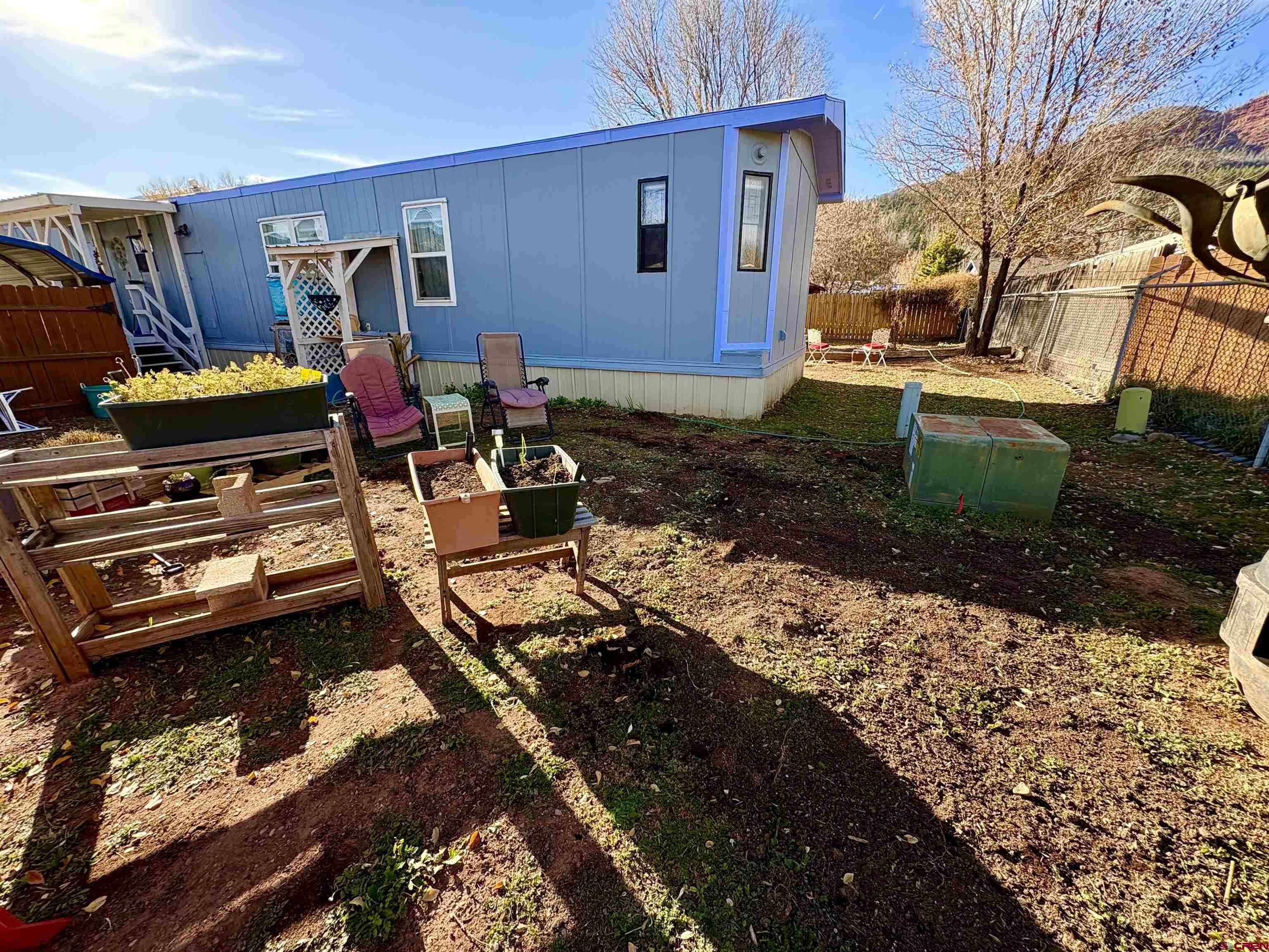 3 Lomas Drive Durango, CO 81301 - Photo 26 of 26 a view of a backyard with chairs and a stove