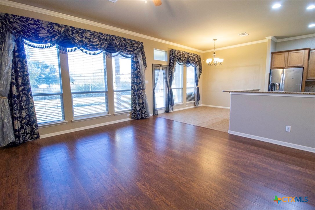 7022 Valley Mist Drive Temple, TX 76502 - Photo 18 of 36 a view of an empty room with wooden floor and a window