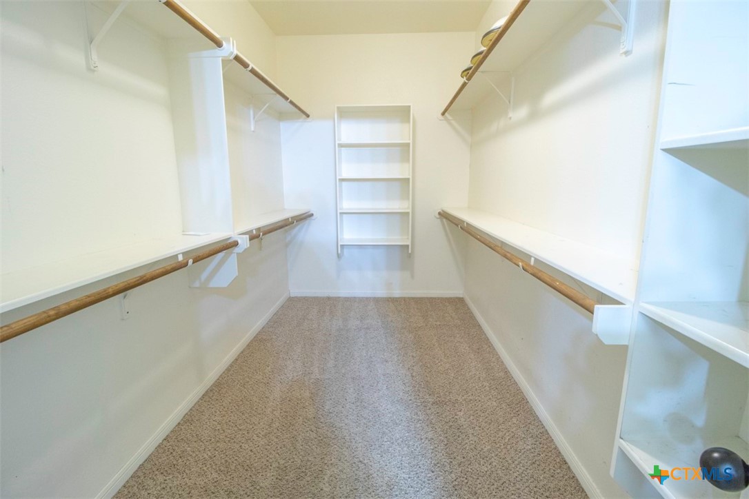 7022 Valley Mist Drive Temple, TX 76502 - Photo 24 of 36 a view of a hallway with wooden floors and stairs