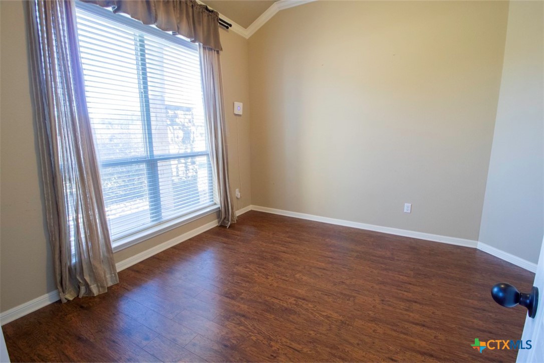 7022 Valley Mist Drive Temple, TX 76502 - Photo 8 of 36 an empty room with wooden floor and windows