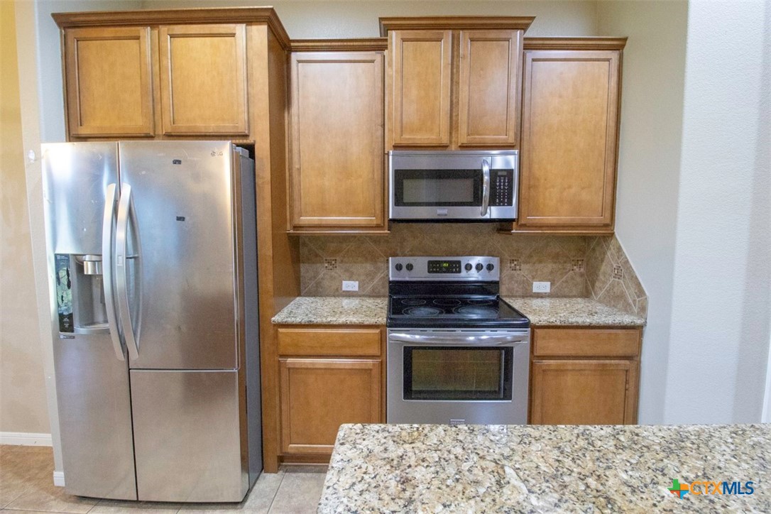 7022 Valley Mist Drive Temple, TX 76502 - Photo 10 of 36 a kitchen with a refrigerator sink and microwave