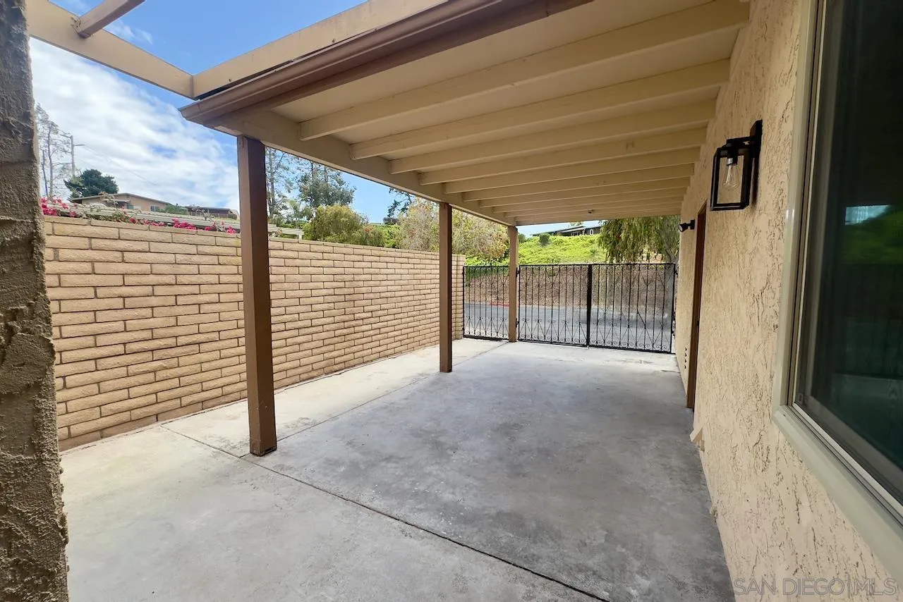 4529 Kittiwake Way Oceanside, CA 92057 - Photo 19 of 23 a view of a porch with a table and chairs and floor to ceiling window