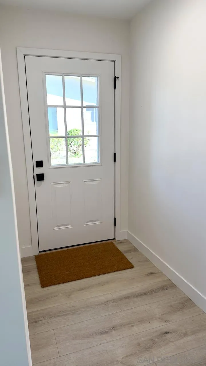 4529 Kittiwake Way Oceanside, CA 92057 - Photo 6 of 23 an empty room with wooden floor and windows