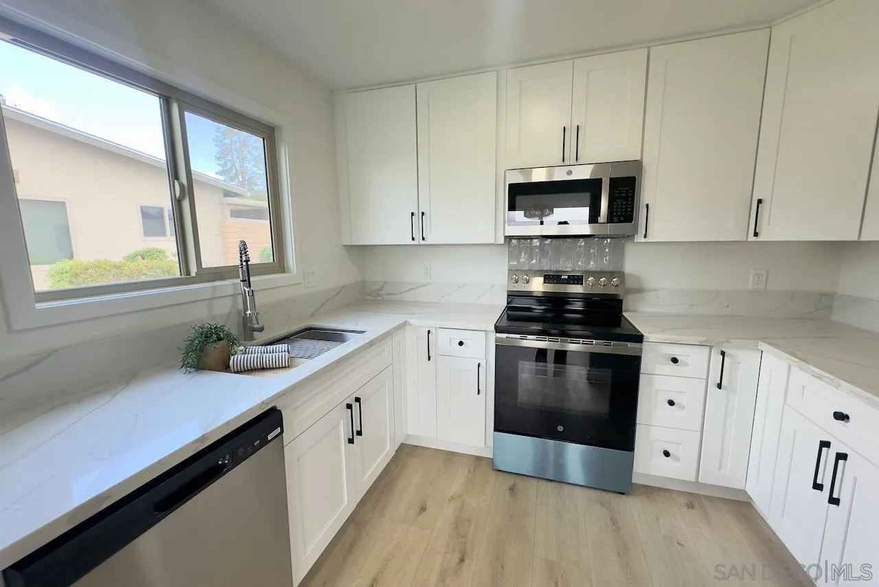 4529 Kittiwake Way Oceanside, CA 92057 - Photo 9 of 23 a kitchen with stainless steel appliances granite countertop a sink a stove and a refrigerator