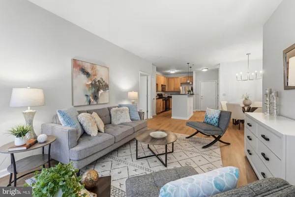 a living room with furniture and view of kitchen