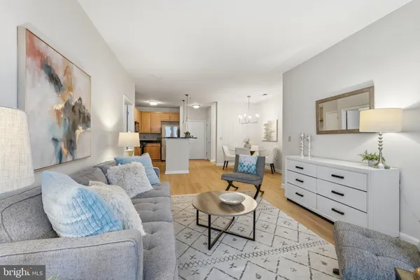a living room with furniture and a view of kitchen