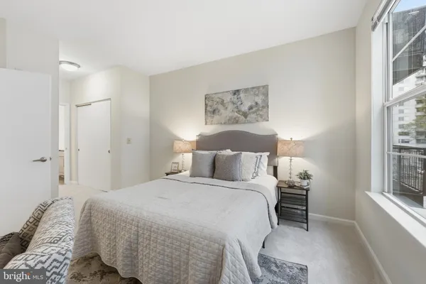 a bedroom with a bed and a window