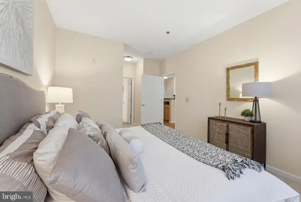 a bedroom with a bed and a lamp on table
