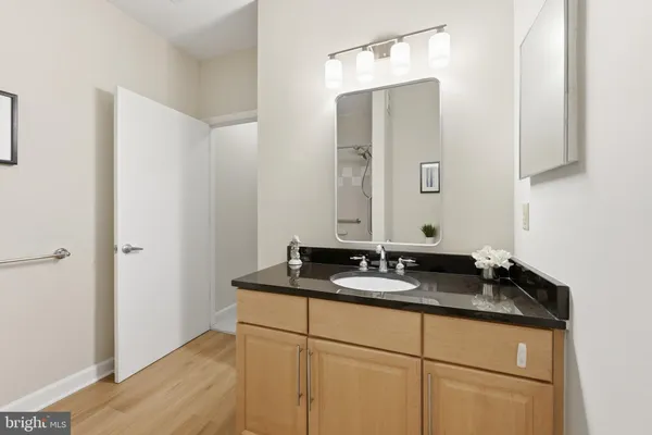 a bathroom with a granite countertop sink and a mirror