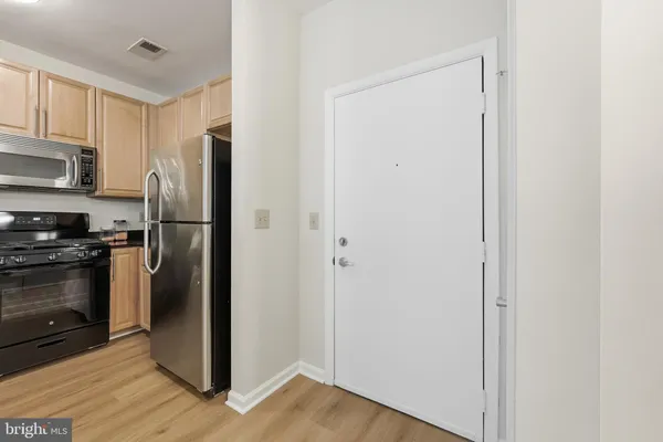 a kitchen with a refrigerator cabinet and a sink