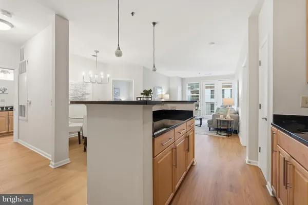 a kitchen with kitchen island a stove a sink and wooden floor