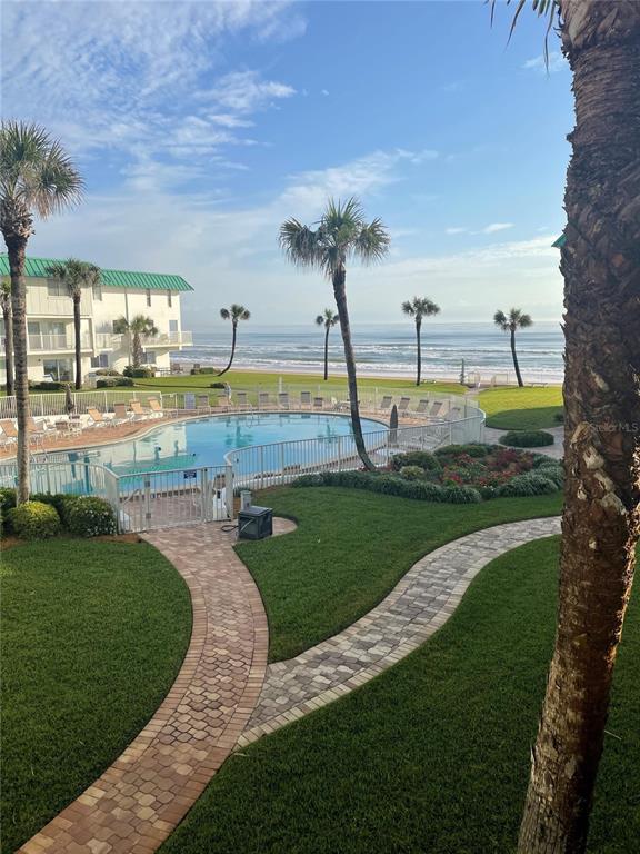 815 Ocean Shore Boulevard, Unit 5B Ormond Beach, FL 32176 - Photo 1 of 1 a view of a swimming pool and a garden