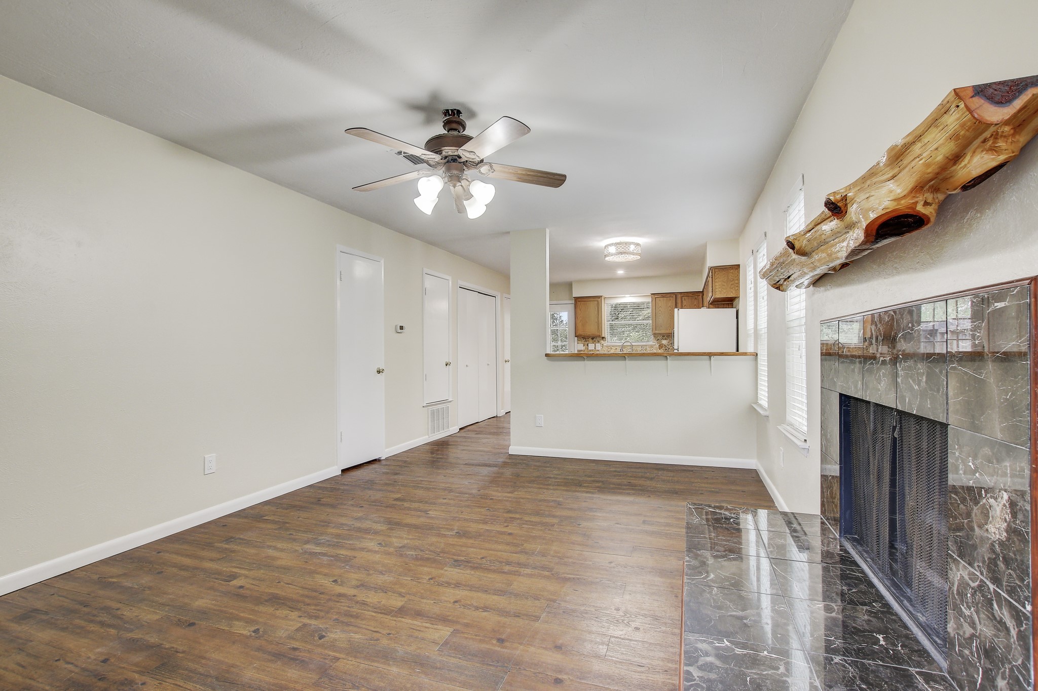 6902 Rifle Bend Austin, TX 78736 - Photo 9 of 33 a view of empty room with wooden floor and fireplace