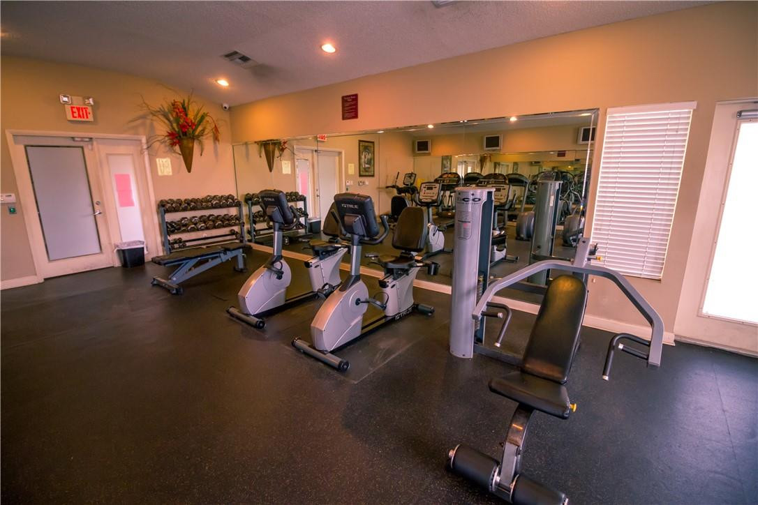 801 Lyons Road, Unit 19203 Coconut Creek, FL 33063 - Photo 2 of 3 a view of a room with gym equipment