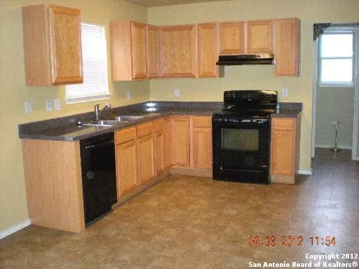 a kitchen with a stove and a sink