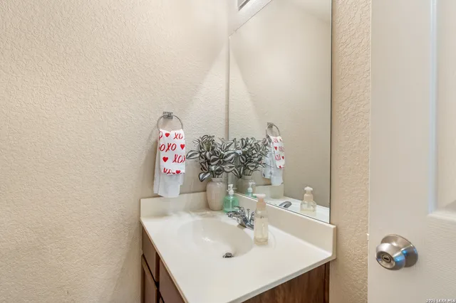 a bathroom with a sink vanity and a mirror
